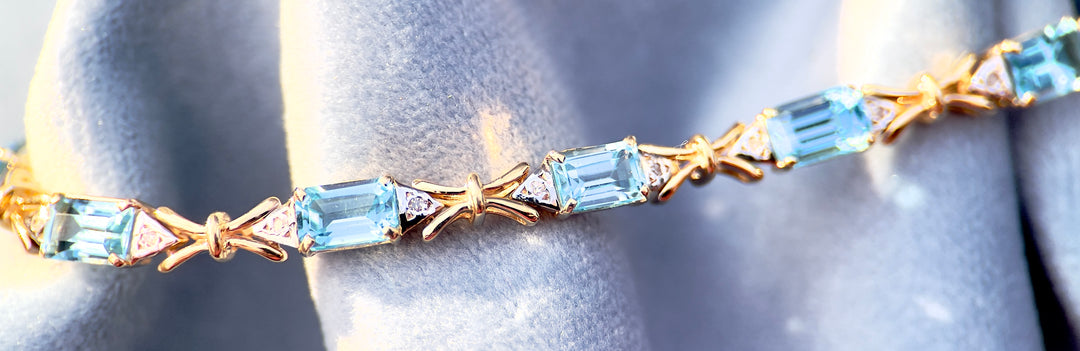 “Frost and Bows” Emerald Cut Blue Topaz with Diamond Accents in 14k Yellow Gold