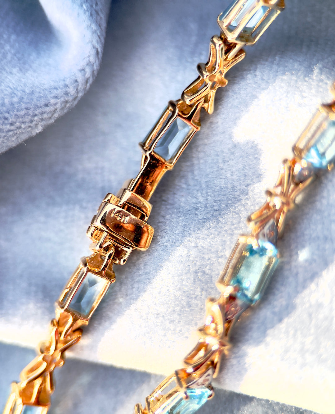 “Frost and Bows” Emerald Cut Blue Topaz with Diamond Accents in 14k Yellow Gold