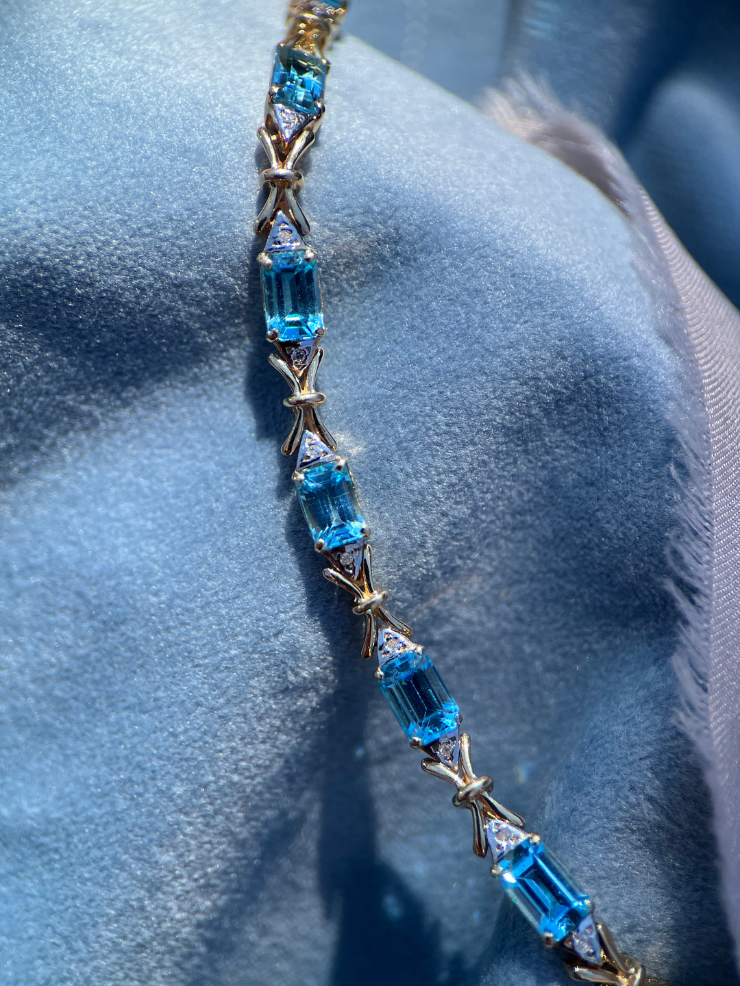 “Frost and Bows” Emerald Cut Blue Topaz with Diamond Accents in 14k Yellow Gold